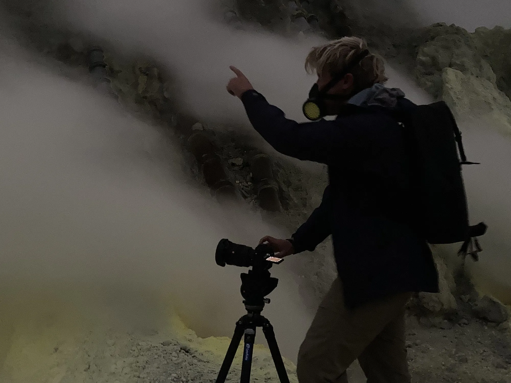 Kevin photographing inside the Ijen crater, gas mask on